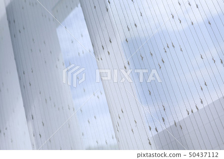 white drapery curtain hanging on the window white drapery curtain hanging on the window 50437112