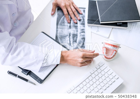 Male doctor or dentist working with patient tooth Male doctor or dentist working with patient tooth 50438348