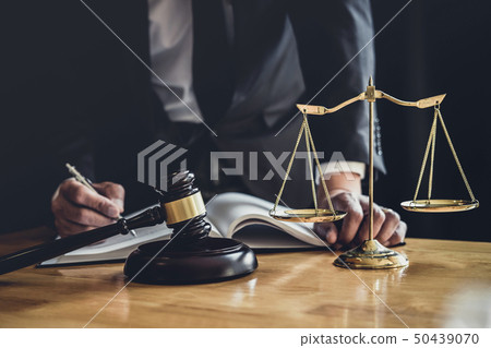 Male lawyer or judge working with contract papers, 50439070