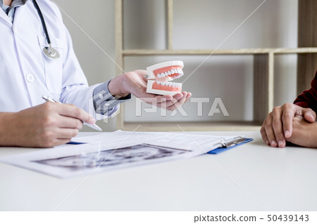 Male doctor or dentist writing report working with Male doctor or dentist writing report working with 50439143