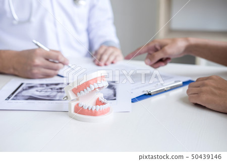 Male doctor or dentist writing report working with Male doctor or dentist writing report working with 50439146