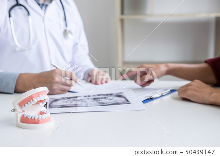Male doctor or dentist writing report working with Male doctor or dentist writing report working with 50439147