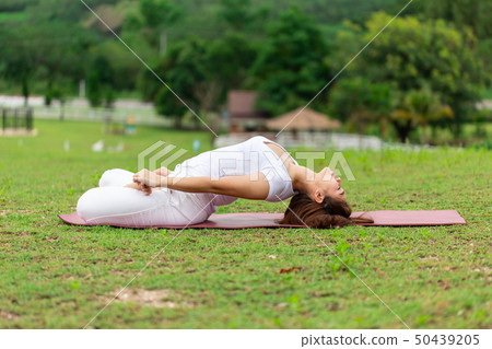woman sitting on yoga mat practice Supta Virasana 50439205