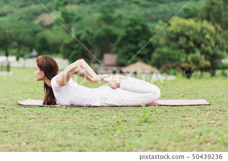 woman practice yoga Frog pose or Bhekasana pose 50439236