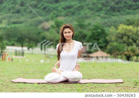 woman sitting on yoga mat practice Baddha Padmasan woman sitting on yoga mat practice Baddha Padmasan 50439263