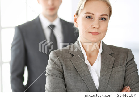 Business woman standing straight with colleague businessman in office, headshot. Success and 50440197