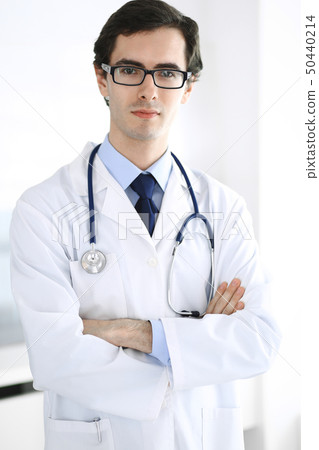 Doctor man standing straight with arms crossed. Perfect medical service in clinic. Happy future in 50440214