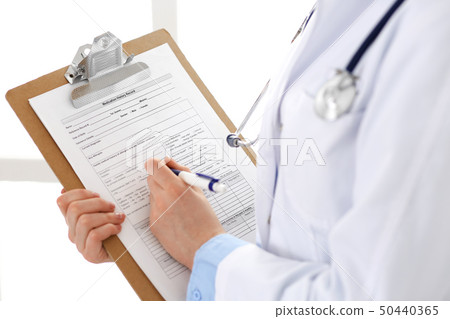 Female doctor using medical form on clipboard closeup. Physicianat work in hospital or clinic 50440365
