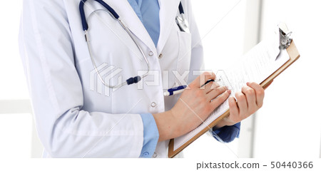 Female doctor using medical form on clipboard closeup. Physicianat work in hospital or clinic 50440366