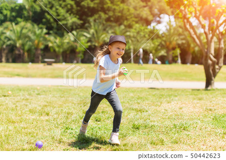 happy baby smiling. Little girl running in the park 50442623