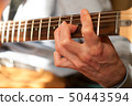 Guitar player strumming 50443594