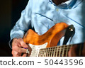 Guitar player strumming 50443596