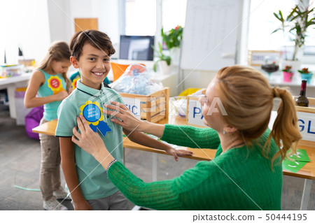 Schoolboy feeling amazing receiving eco friendly award at school Schoolboy feeling amazing receiving eco friendly award at school 50444195