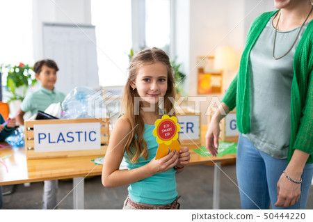 Girl feeling happy after receiving reward for being eco friendly 50444220