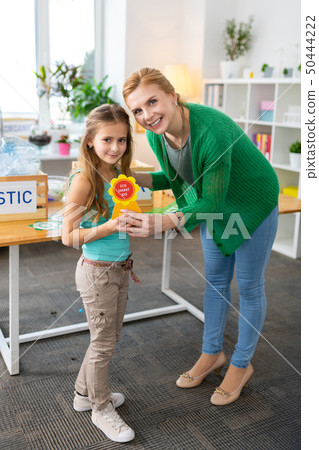 Little girl feeling happy after receiving eco friendly reward 50444222