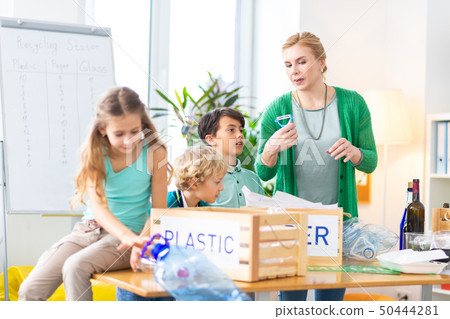 Teacher telling her pupils and importance of waste sorting Teacher telling her pupils and importance of waste sorting 50444281