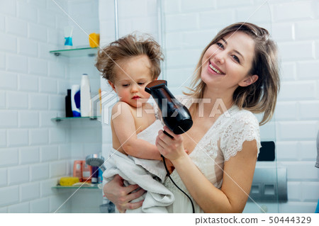 mother and son dry their hair after a shower mother and son dry their hair after a shower 50444329