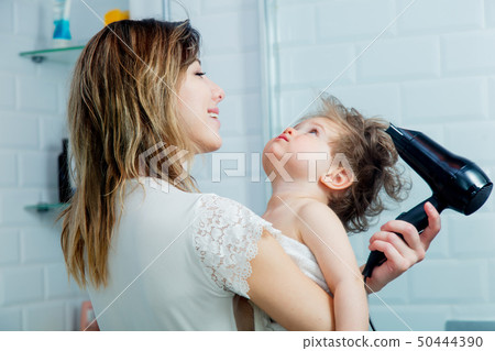 mother and son dry their hair after a shower mother and son dry their hair after a shower 50444390