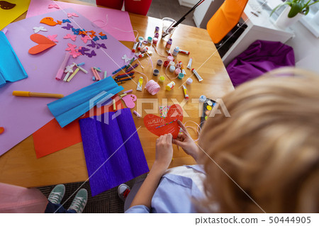 Blonde schoolboy making applied ornament at the lesson 50444905