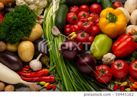 Vegetables and nuts on a brown wooden background 50445162