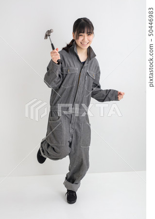 Girl with white background studio photography working clothes working full length industrial girl working with driver Girl with white background studio photography working clothes working full length industrial girl working with driver 50446983