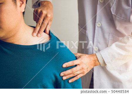 Physical therapists are using their hands to press 50448584