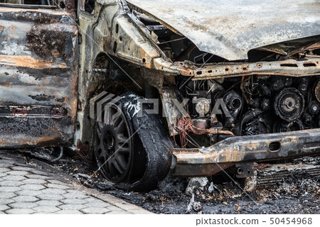 Burnt rusty car on road. Burnt rusty car on road. 50454968