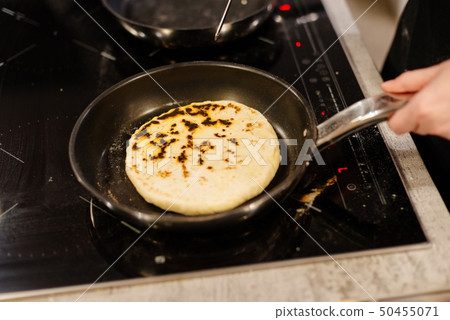 Frying traditional imeruli on frying pan in the Frying traditional imeruli on frying pan in the 50455071