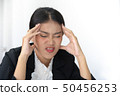 Portrait of frustrated young woman holding hand on 50456253
