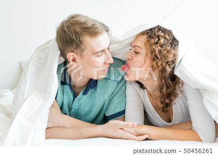 happy couple is lying in bed together. Enjoying 50456261