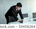 Young asia businessman focused on solving 50456264