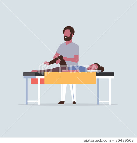 young girl lying on massage table african american masseur therapist doing healing treatment young girl lying on massage table african american masseur therapist doing healing treatment 50459502