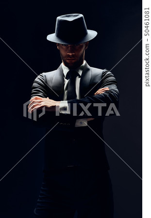 Handsome confident man in black suit and hat with Handsome confident man in black suit and hat with 50461081