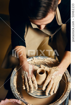 Man potter working on potters wheel making ceramic Man potter working on potters wheel making ceramic 50461133