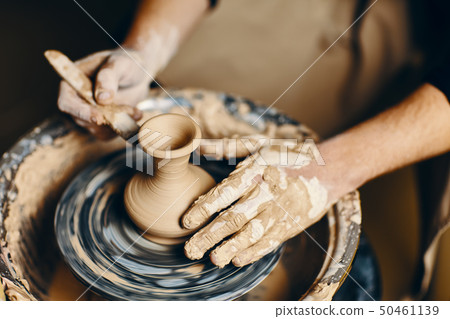 Potter modeling ceramic pot from clay on a 50461139