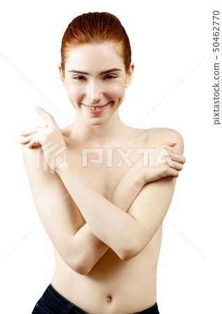 Lovely naked redhead woman covering her breast . Lovely naked redhead woman covering her breast . 50462770