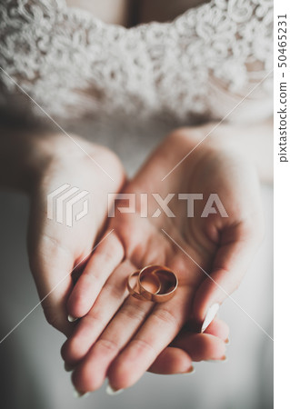 Luxury wedding rings on bride hands. Close focus 50465231