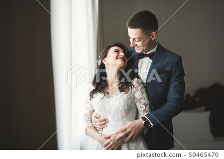 Cute happy bride and groom preparing for wedding Cute happy bride and groom preparing for wedding 50465470
