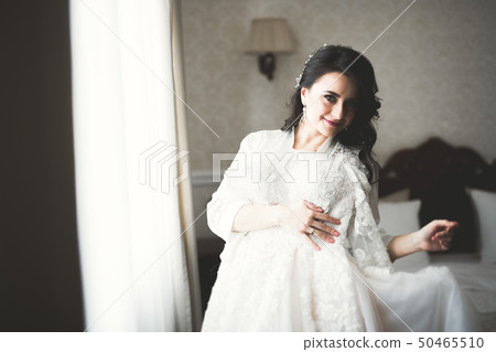 Portrait of beautiful bride with fashion veil at wedding morning Portrait of beautiful bride with fashion veil at wedding morning 50465510