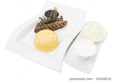 Beef tenderloin and a hominy with white cheese. 50468016
