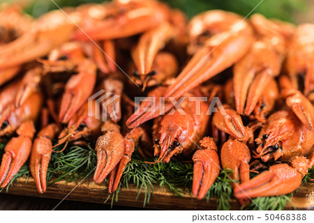 Pile of boiled crayfish on rustic wooden background 50468388