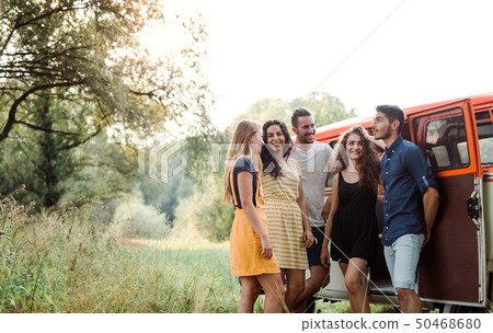 A group of young friends on a roadtrip through countryside. 50468680