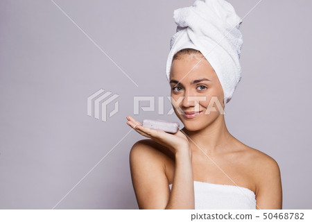 A portrait of young woman with a bar of soap in a studio, beauty and skin care. A portrait of young woman with a bar of soap in a studio, beauty and skin care. 50468782