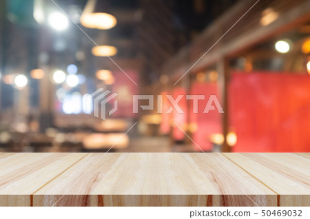 Empty wooden table top with blurred coffee shop. Empty wooden table top with blurred coffee shop. 50469032