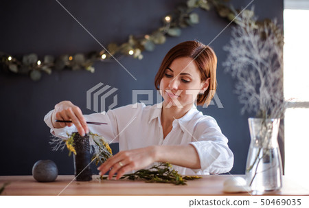Young creative woman in a flower shop. A startup of florist business. Young creative woman in a flower shop. A startup of florist business. 50469035