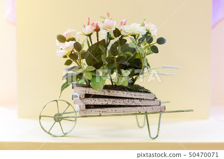 Arrangement of artificial flowers in a bed on 50470071