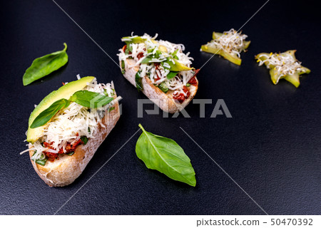 Tasty savory tomato Italian appetizers on black background. Italian food. 50470392