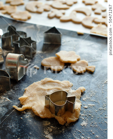 Close up of cookie cutters in a dough 50471267