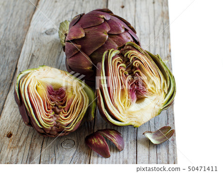 Roman Artichokes on a wooden board Roman Artichokes on a wooden board 50471411