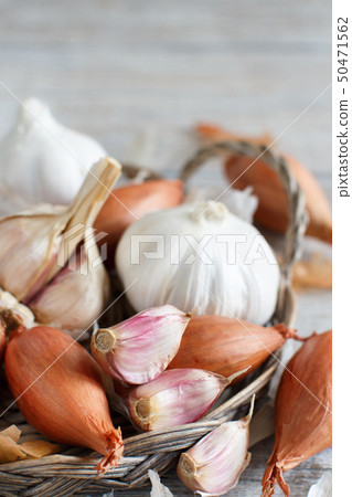 Organic garlic and onion on wooden table Organic garlic and onion on wooden table 50471562